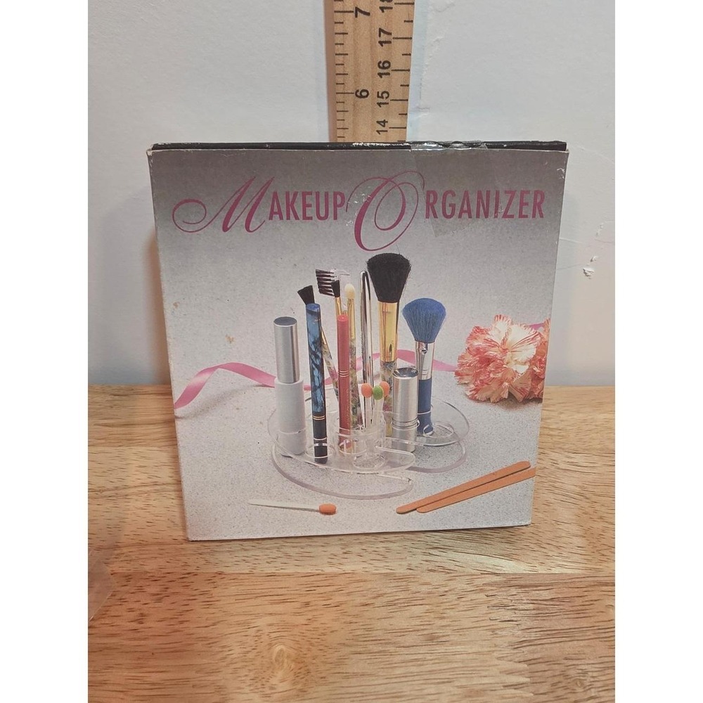 1990s NOS clear acrylic makeup organizer featuring tiered slots for holding